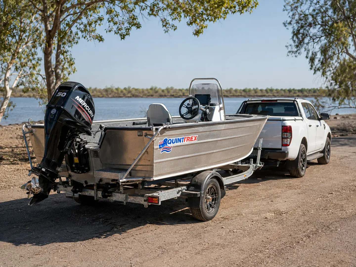 Illustrative scene: A Quintrex aluminium fishing boat on its registered single-axle road trailer near a boat ramp in remote Northern Territory Australia. Not the actual customer or their asset.